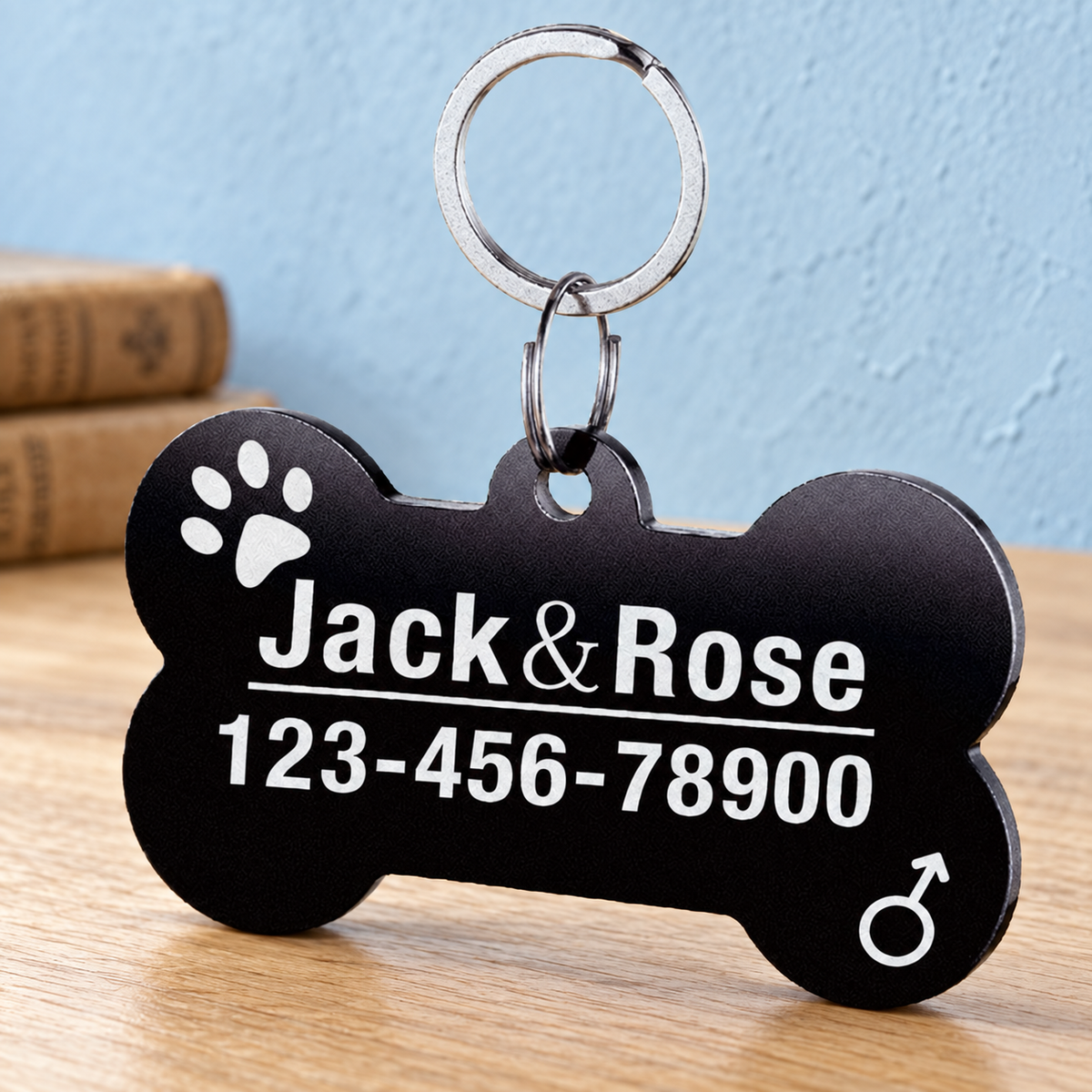 Black classic bone engraved pet ID tag on light oak with pale blue wall