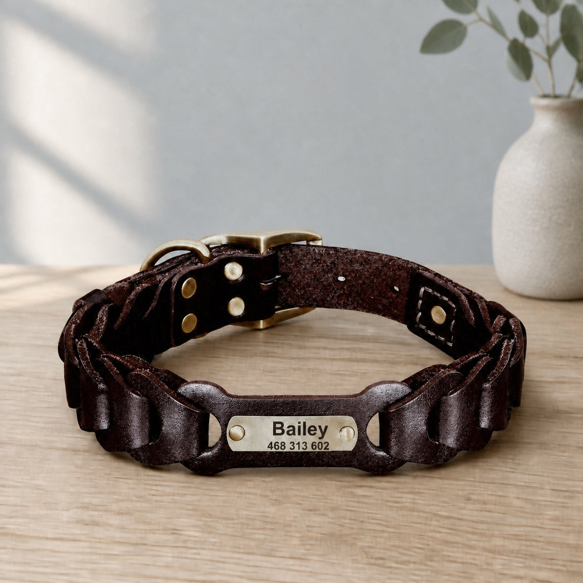Dark brown braided leather collar with engraved Bailey nameplate