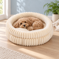 The Heritage Nest ribbed plush pet bed in Beige with a small dog