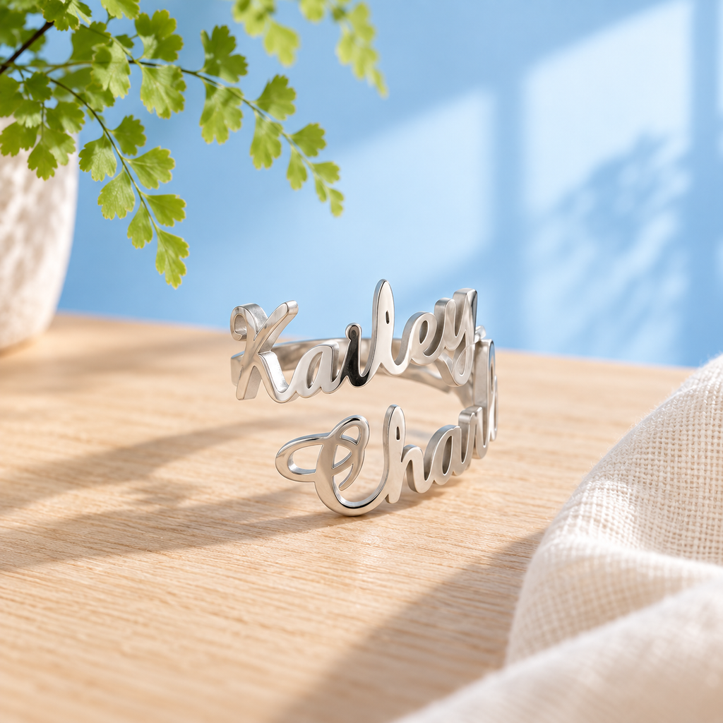Personalised two-name stainless steel ring in Silver with ivory linen against the Cary & Co blue background